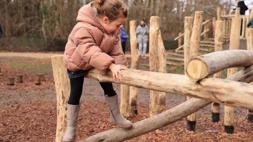 A girl sits on balance beams